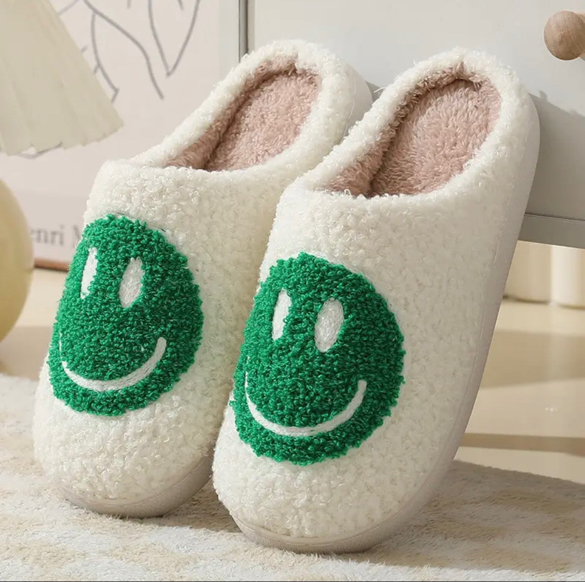 Indulge in the cuteness and charm of our Plush Happy Face Slippers. Made from high quality boucle fabric, these luxuriously soft slippers are the epitome of comfort. With their heartwarming design, walking around the house will feel like a dream. Say goodbye to cold feet and hello to cozy luxury.