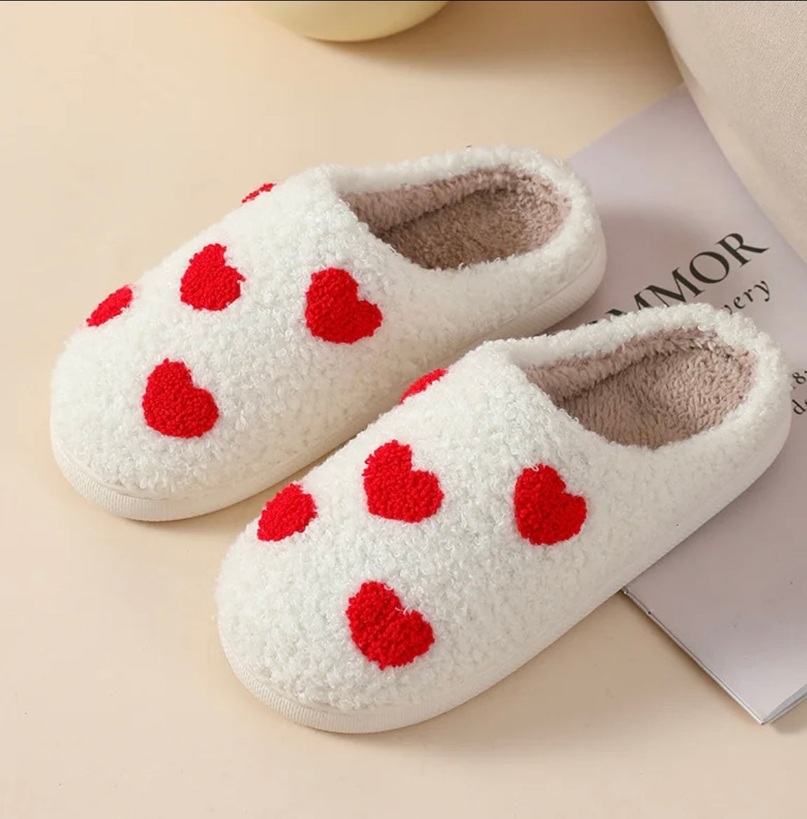 Indulge in the cuteness and charm of our Plush Happy Face Slippers. Made from high quality boucle fabric, these luxuriously soft slippers are the epitome of comfort. With their heartwarming design, walking around the house will feel like a dream. Say goodbye to cold feet and hello to cozy luxury.