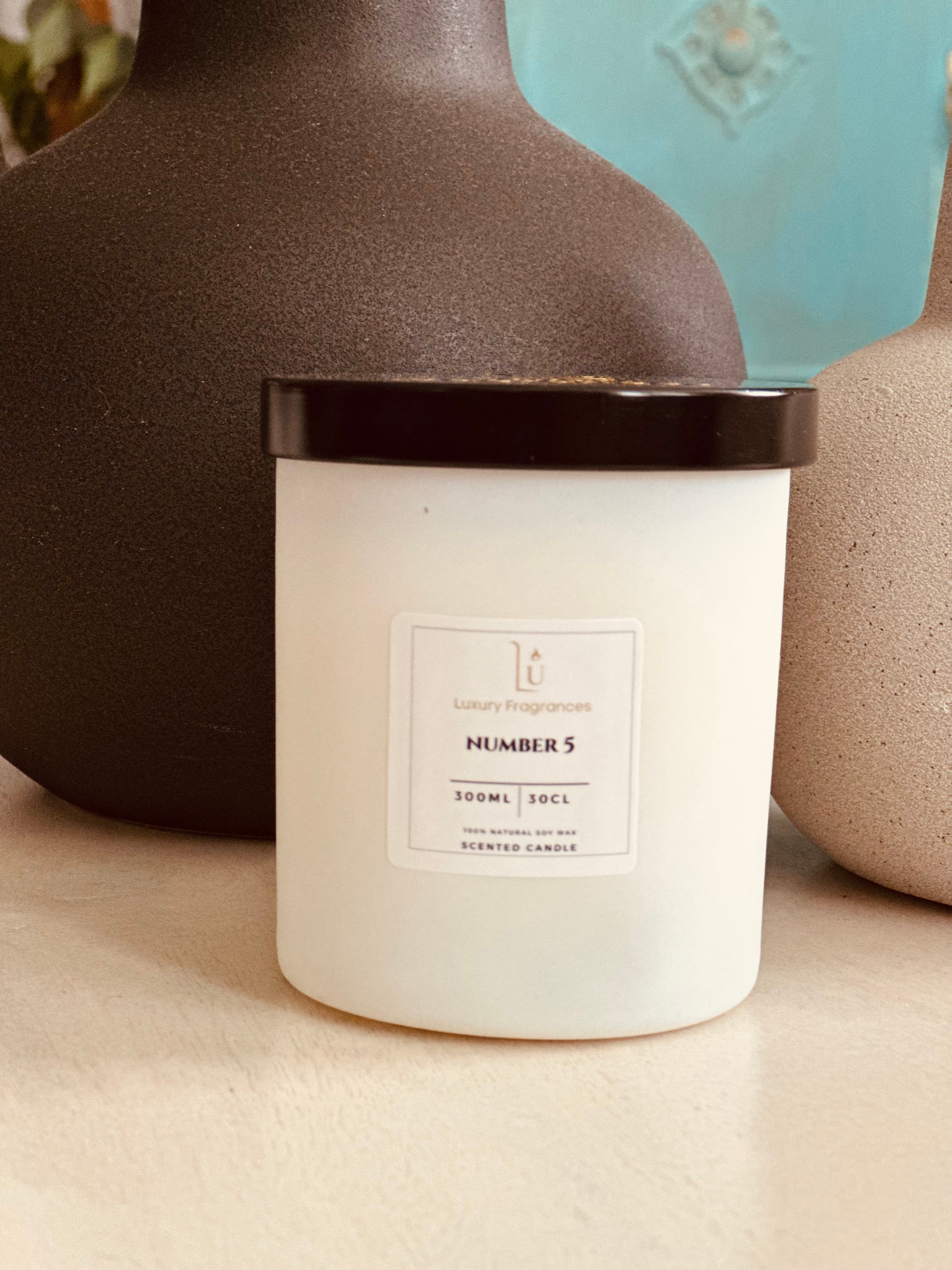 Experience luxury and sophistication with our Matte White Scented Candle from our Signature Range.

Featuring a choice of lid colour and infused with the iconic Number 5 scent, a perfect dupe of Chanel. Light up your space with a touch of elegance and indulge in the indulgent fragrance.