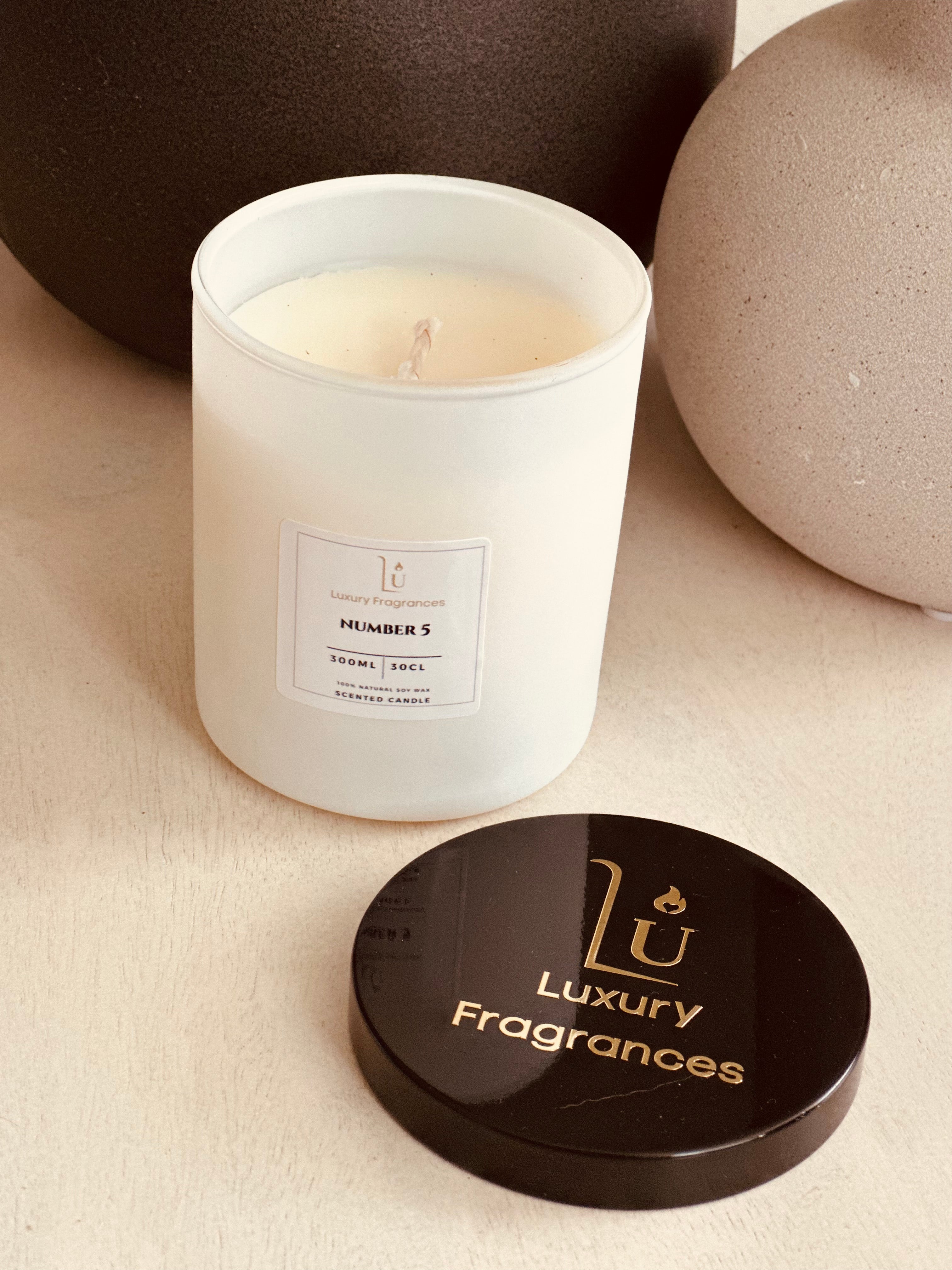 Experience luxury and sophistication with our Matte White Scented Candle from our Signature Range.

Featuring a choice of lid colour and infused with the iconic Number 5 scent, a perfect dupe of Chanel. Light up your space with a touch of elegance and indulge in the indulgent fragrance.