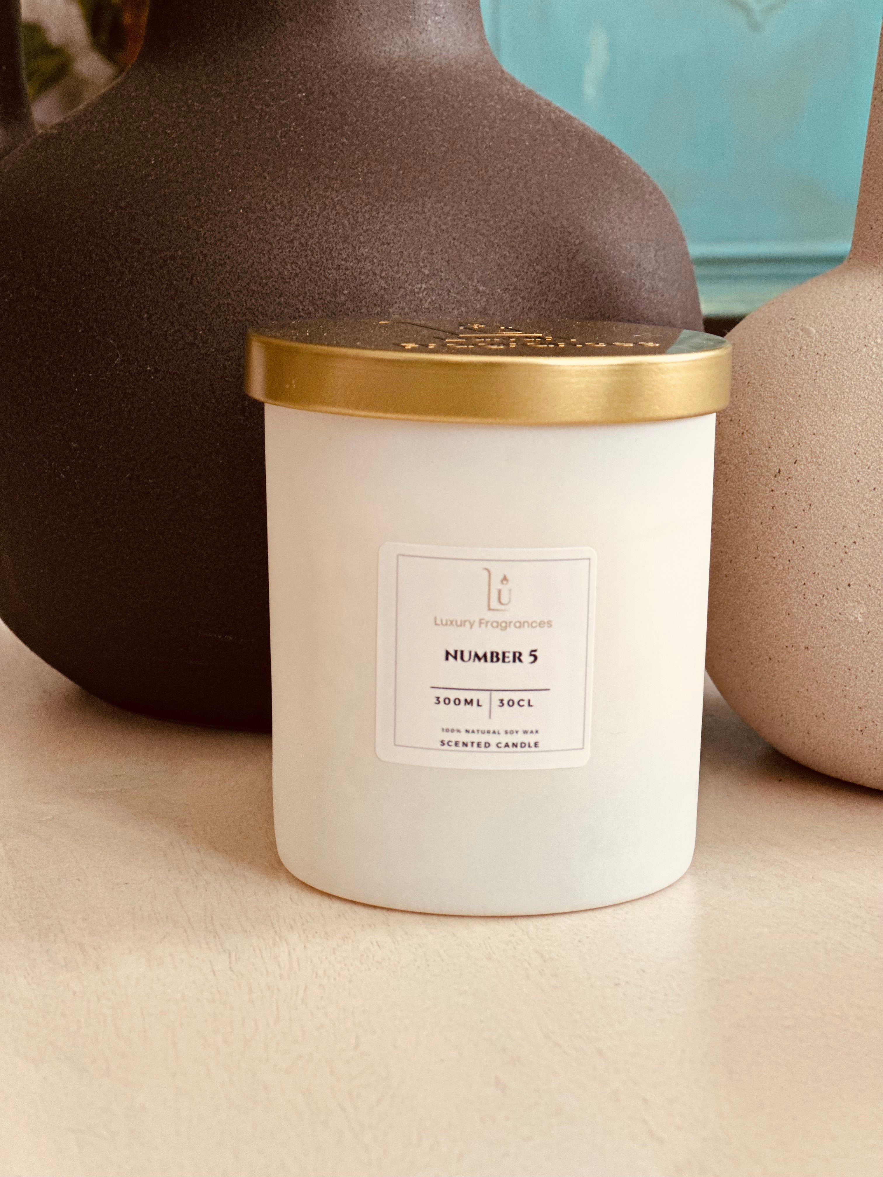 Experience luxury and sophistication with our Matte White Scented Candle from our Signature Range.

Featuring a choice of lid colour and infused with the iconic Number 5 scent, a perfect dupe of Chanel. Light up your space with a touch of elegance and indulge in the indulgent fragrance.