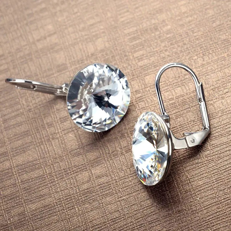 Experience timeless elegance with our Crystal Drop Earrings. These stunning earrings feature high-quality crystals that catch the light and add a touch of sparkle to any outfit. With their classic design and versatile style, these earrings are perfect for any occasion. Elevate your look with our Crystal Drop Earrings.