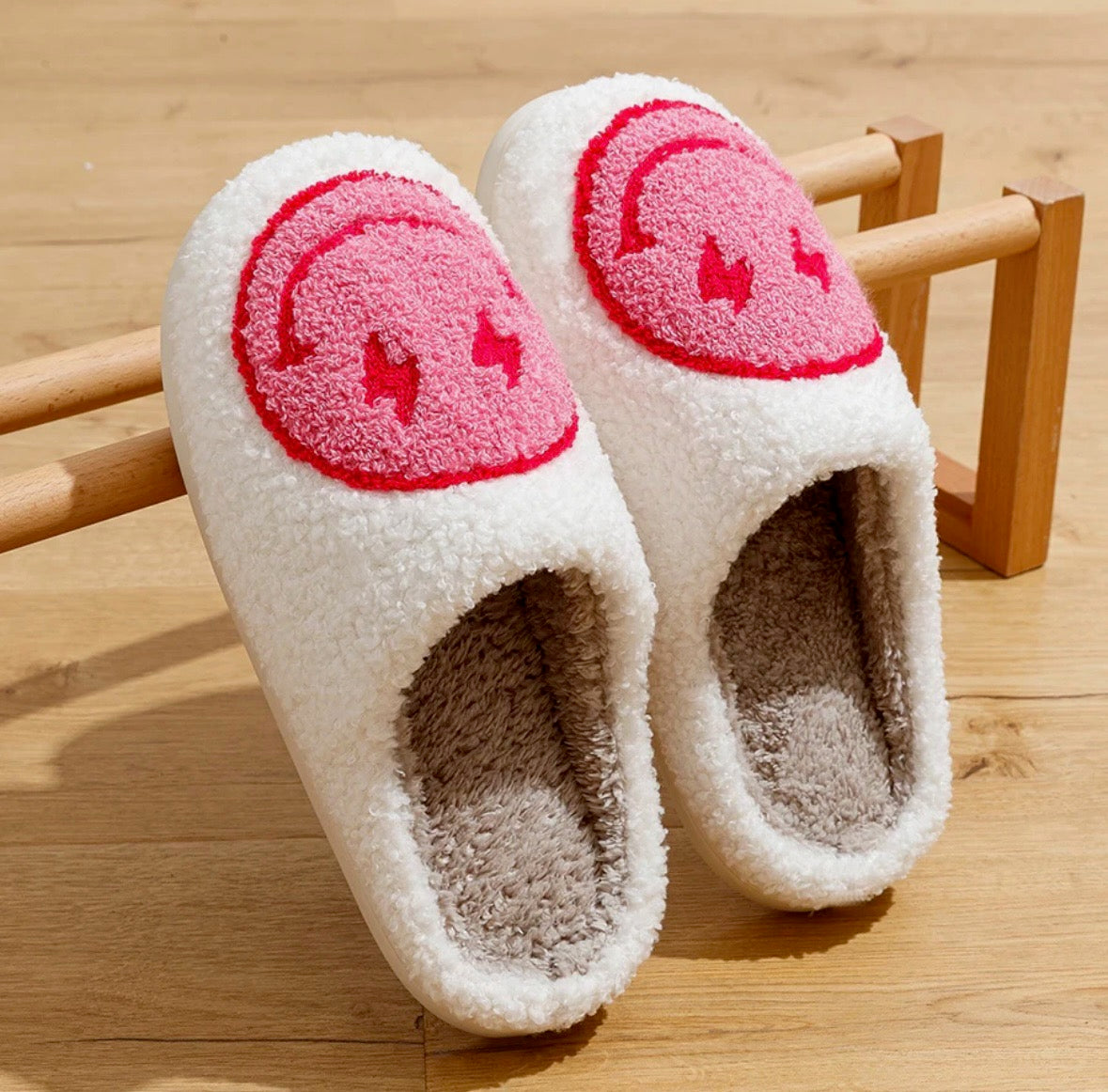 Indulge in the cuteness and charm of our Plush Happy Face Slippers. Made from high quality boucle fabric, these luxuriously soft slippers are the epitome of comfort. With their heartwarming design, walking around the house will feel like a dream. Say goodbye to cold feet and hello to cozy luxury.