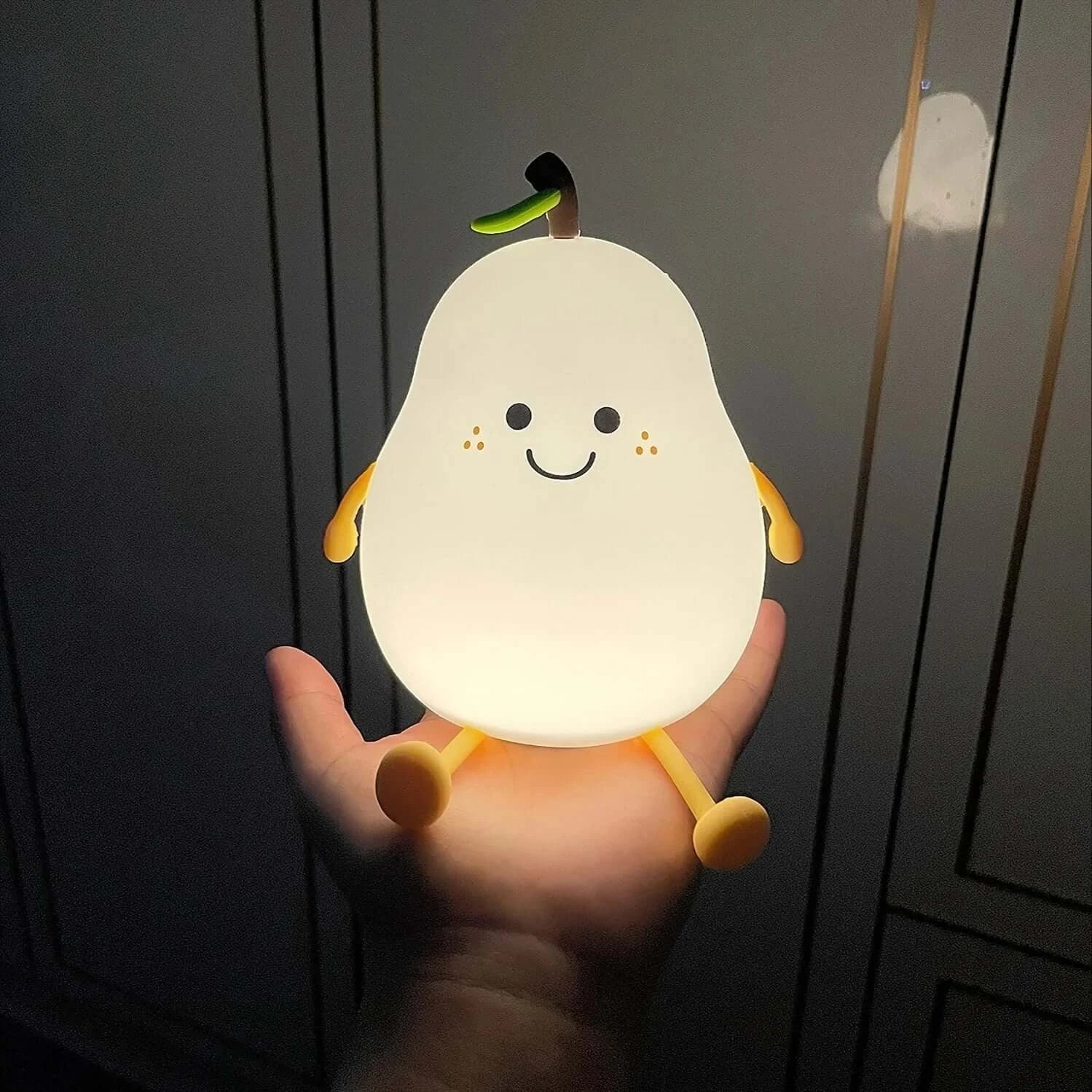 Introducing the Kids Peter Pear Night Light - the perfect addition to your child's room! Made with soft body silicon, this night light emits a soothing glow that changes colors, creating a calming atmosphere for bedtime. Say goodbye to the dark and hello to a good night's sleep for your little one.